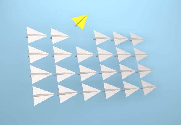 istock Change concepts. Yellow paper airplane leading among white 1330718522