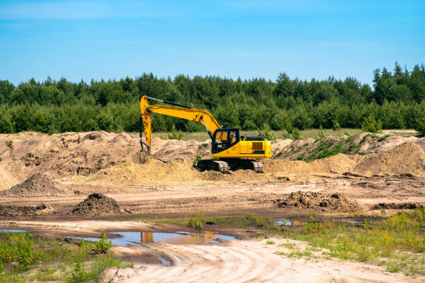 istock An industrial yellow excavator develops in a sandpit quarry. Industry, technology, mining. Heavy industrial machinery 1330720532