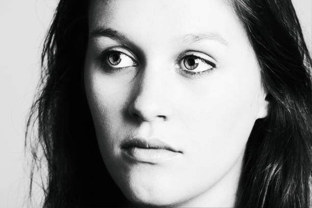 istock Beautiful young woman stares ahead with a blank or serene expression 1330722038
