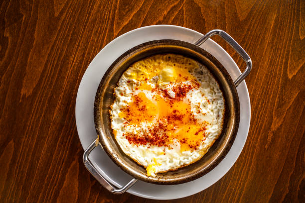 istock Delicious fried eggs on wooden background with space for text.  View from above. 1330722649