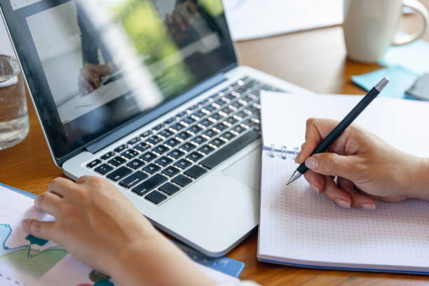 istock Close up female hands during working office day. Using laptop, modern gadgets. Remote working. Workplace at office with PC, devices. 1330722995