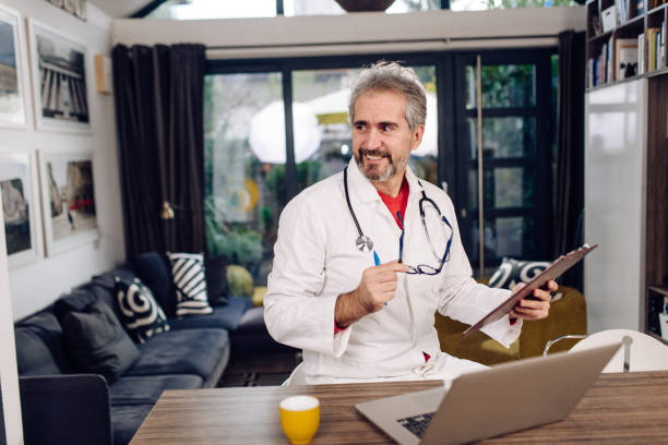 istock Mature doctor working online from home with patients 1330724007
