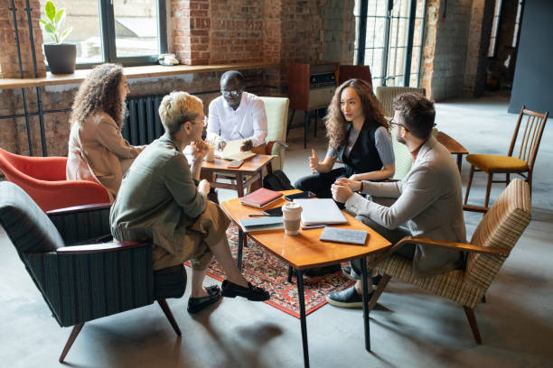 istock Young businesswoman explaining her colleagues one of working points 1330724969
