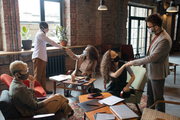 istock Young managers greeting one another by punch bump 1330724979