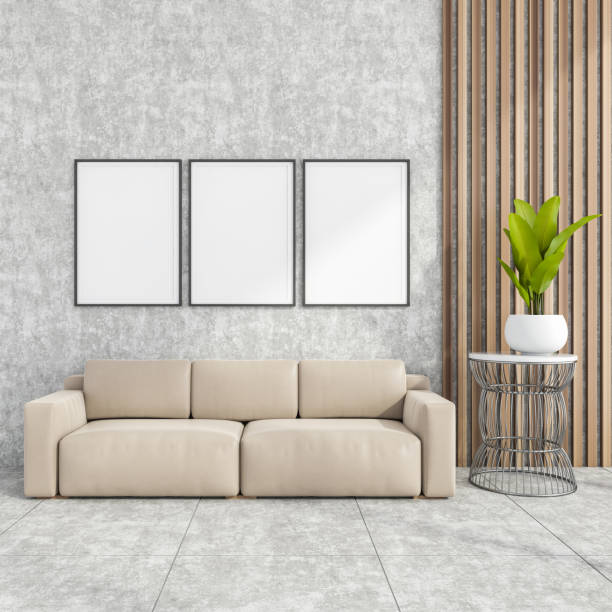 istock Stylish modern office interior, waiting room, with design leather couch, three white mock up framed poster, tile ceramic floor. No people. 1330728432