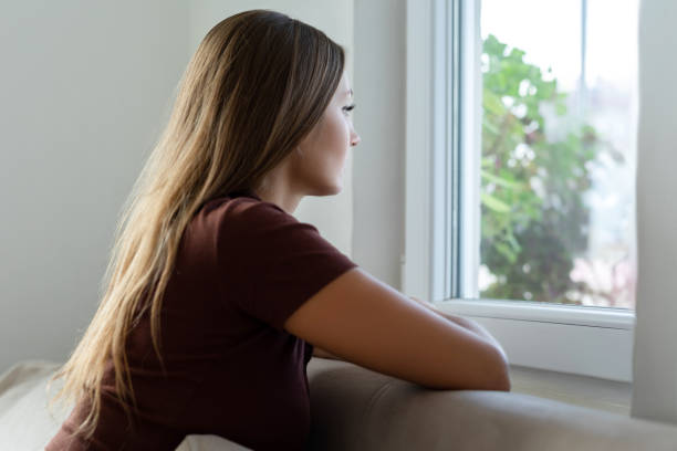 istock Sad young woman watching out 1330729255