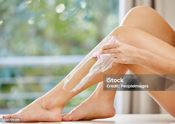Cropped Shot Of An Unrecognizable Woman Shaving Her Legs In The Bathroom Stock Photo - Download Image Now