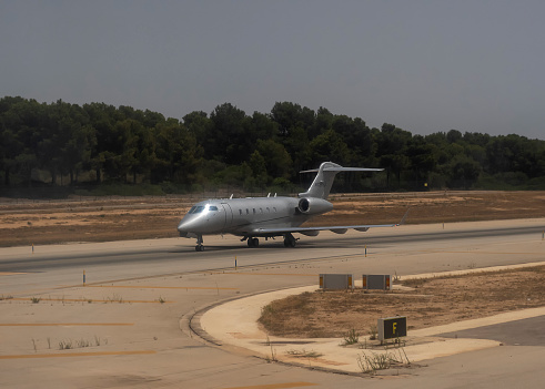 Palma, Mallorca, Spain - July 2021: A Bombardier Challenger 300 private jet on the taxiway at Palma de Mallorca airport in Spain