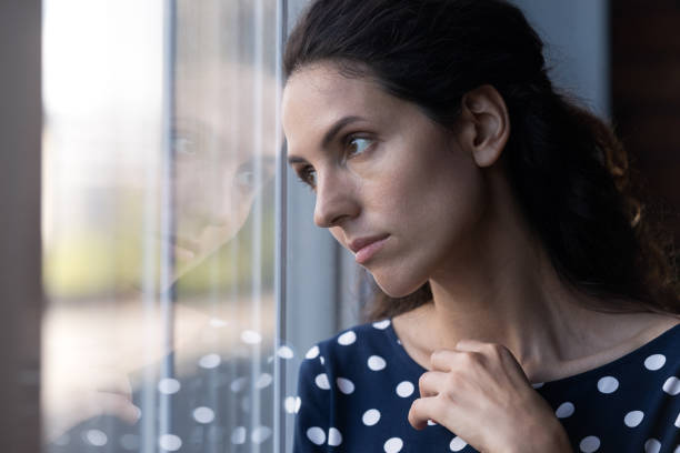 istock Sad thoughtful Hispanic woman looking out window in deep thought 1330730695