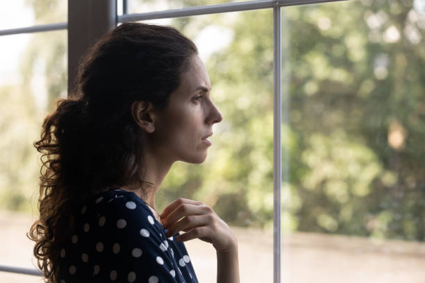 istock Frustrated depressed millennial woman looking out window 1330730706