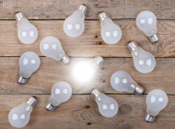 istock Vintage bulbs on wooden background - idea, innovation, teamwork and leadership concept. Space for text 1330730842