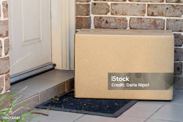 Parcel Box Delivered To A Front Door Of Residential Building Stock Photo - Download Image Now