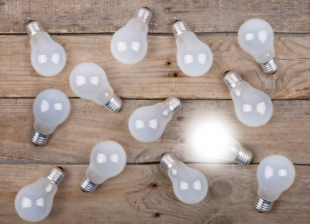 istock Vintage bulbs on wooden background - idea, innovation, teamwork and leadership concept. Space for text 1330732590
