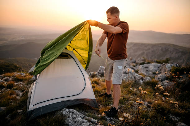 istock Mature man installing tent on hiking 1330734125