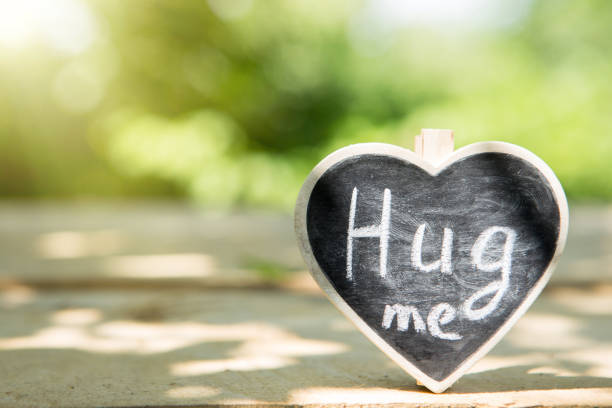 istock Hug me hand drawing phrase on a heart, Share a Hug Day concept 1330734938