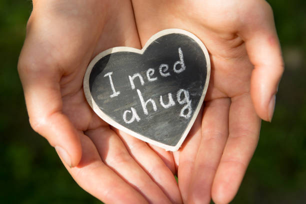 istock Little heart with I Need a Hug phrase in a hands. Sharing a Hug concept 1330736003