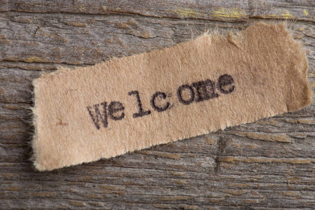 istock Welcome - word printed on typewriter, wooden background, vintage style 1330736351