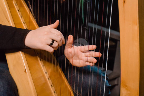 istock The girl's hands are plucking the harp strings 1330740539