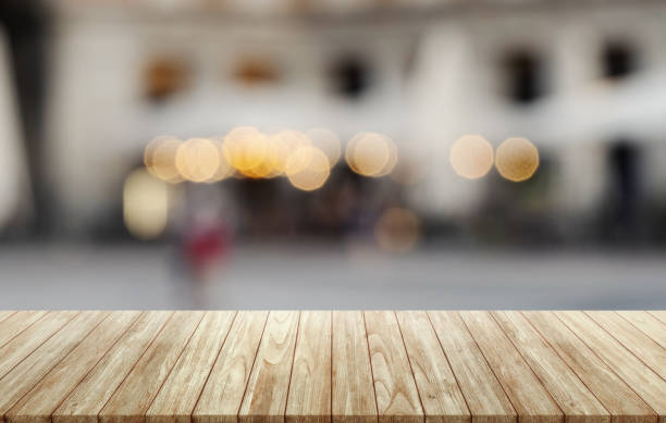 istock Empty wooden table on abstract blurred white interior background, assembly, product display, interior and window. 1330741662