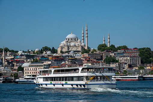 Istanbul,Turkey- July 09,2021:Istanbul Landscape. Passenger Boats Are At Golden Horn, Suleymaniye Mosque Is On A Background