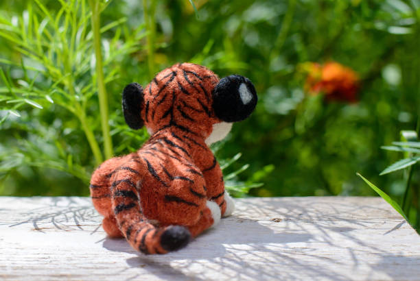 istock Toy handmade tiger, felting wool, rear view 1330742600