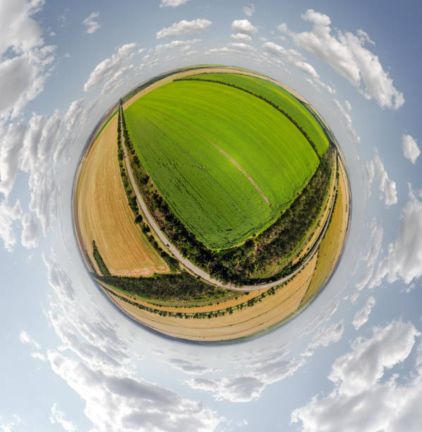 Small planet with a view of a bridge, wheat and corn fields under the blue sky in Moldova, spherical panorama on DJi Mavic Mini 2