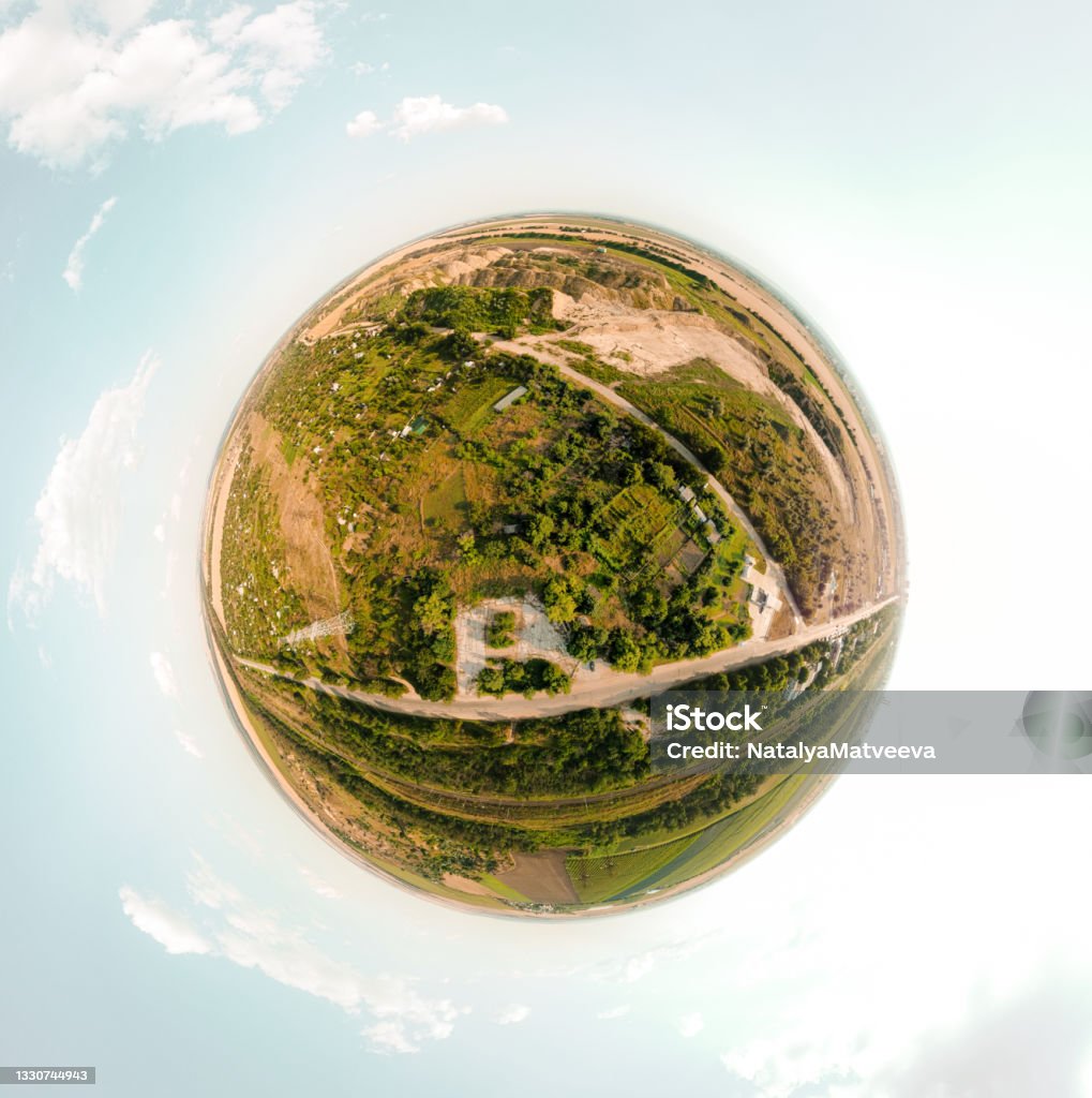 Small planet with a view of a sand quarry and a city under the blue sky in Moldova, spherical panorama on DJi Mavic Mini 2 Above Stock Photo