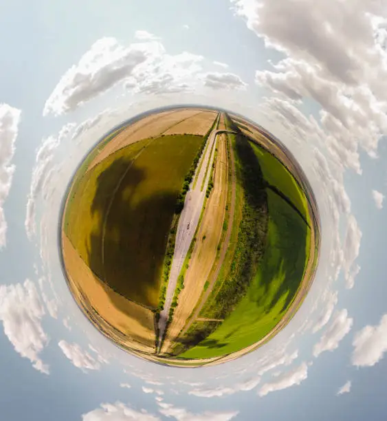 Small planet with a view of a bridge and wheatfields under the blue sky in Moldova, spherical panorama on DJi Mavic Mini 2
