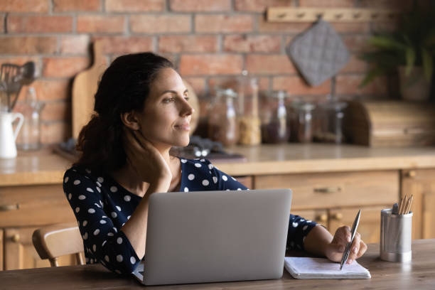 istock Happy thoughtful remote employee, working at laptop form home 1330745907