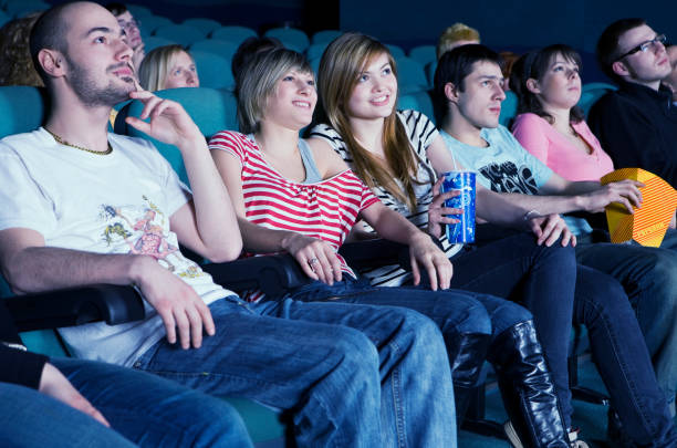 istock Smiling audience in movie theater 1330746050