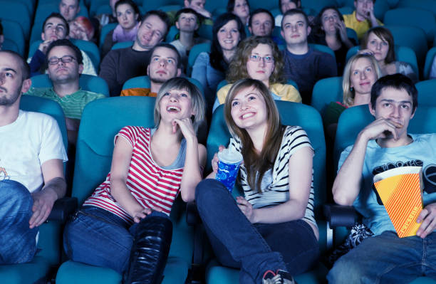 istock Smiling audience in movie theater 1330746092