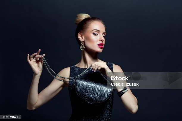 Portrait Of Elegant Woman Holding Evening Bag Stock Photo - Download Image Now - Fashion, One Woman Only, Purse