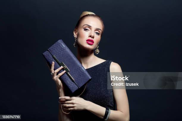 Portrait Of Elegant Woman Holding Hand Bag Stock Photo - Download Image Now - Purse, Women, Sensuality