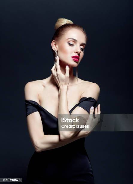 Portrait Of Elegant Woman On Back Background Stock Photo - Download Image Now - Beautiful Woman, Black Color, Dress