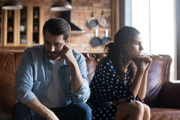 istock Angry young husband and wife sitting together, hating, ignoring 1330749984