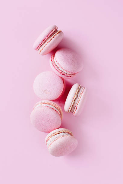 istock Tasty french macarons on a pink pastel background. 1330751139