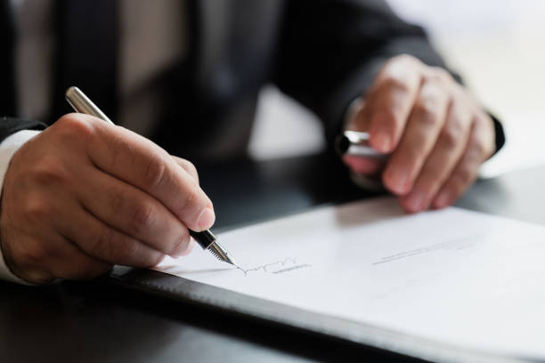 businessman signing contract in the office - desk corporate business business paper imagens e fotografias de stock