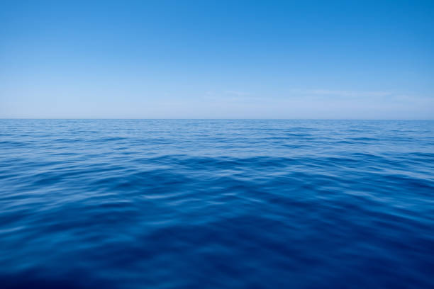 istock Sea water surface calm with small ripples, deep blue color and blue sky background, 1330752321