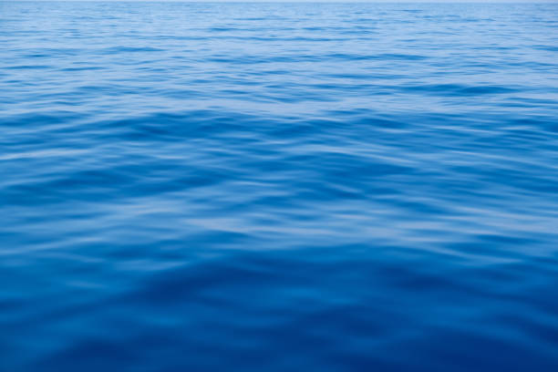 istock Sea water surface calm with small ripples. Still ocean, deep blue color background, 1330752329