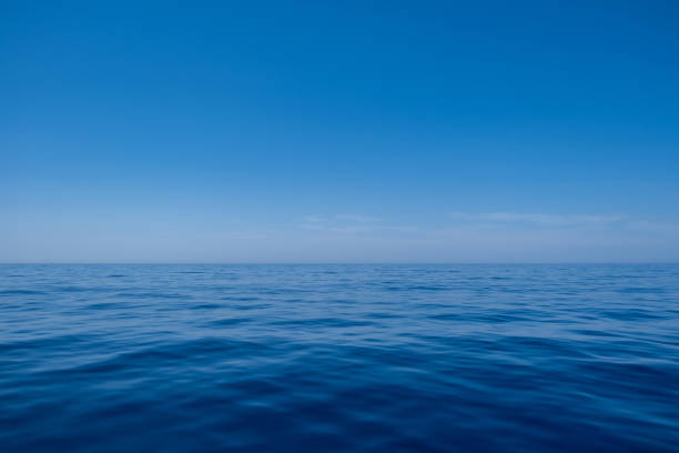 istock Sea water surface calm with small ripples, deep blue color and blue sky background, 1330752333
