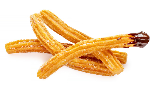 Churros  fried dough pastry with sugar and chocolate sauce isolated on a white background. Churro sticks, top view\