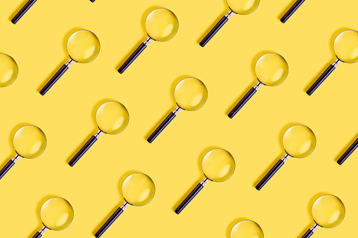 Magnifying glass on the yellow background
