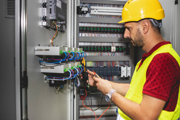 istock Electrician engineer work tester measuring voltage and current of power electric line in electical cabinet control. 1330756832