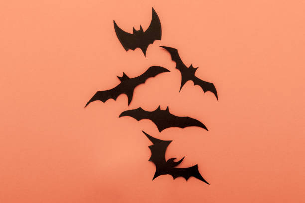 istock Halloween orange pattern background with black bats. Modern design. Holiday party decoration. Flat lay. 1330758299