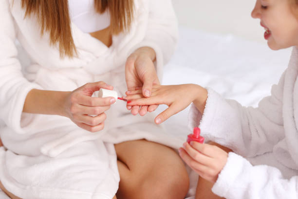 istock Crop mother doing manicure to daughter 1330758309