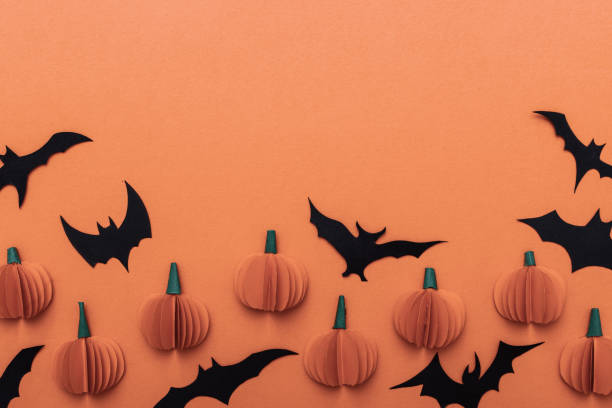 istock Halloween orange pattern background with black bats and pumpkin. Modern design. Holiday party decoration. Flat lay. 1330758331