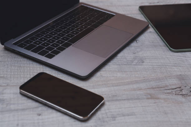 istock Connected office with laptop, tablet and mobile phone on wooden table. 1330760145