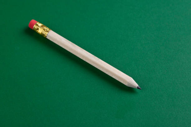 Close up of a Sharpened Pencil Isolated on Green Background
