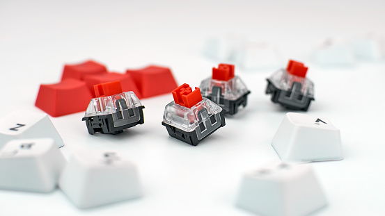 Mechanical keyboard switches. Red switches of the gaming mechanical keyboard, selective focus.