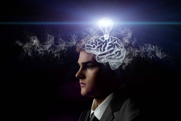 istock A businessman generates ideas in his brain on a black background. 1330762482